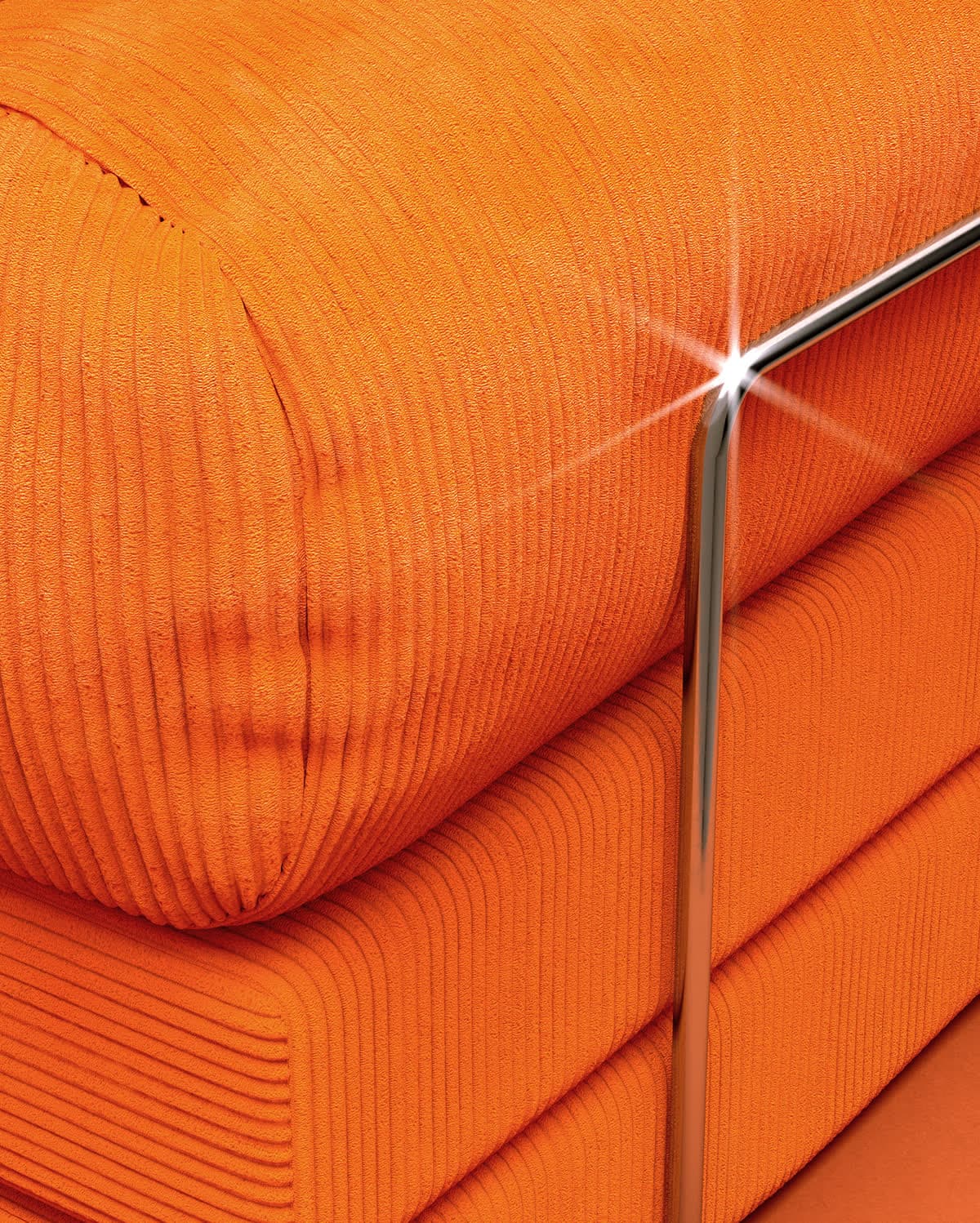 A TEDDY sofa in orange corduroy, close up on the arm bolster, with the Etsy listing card over it