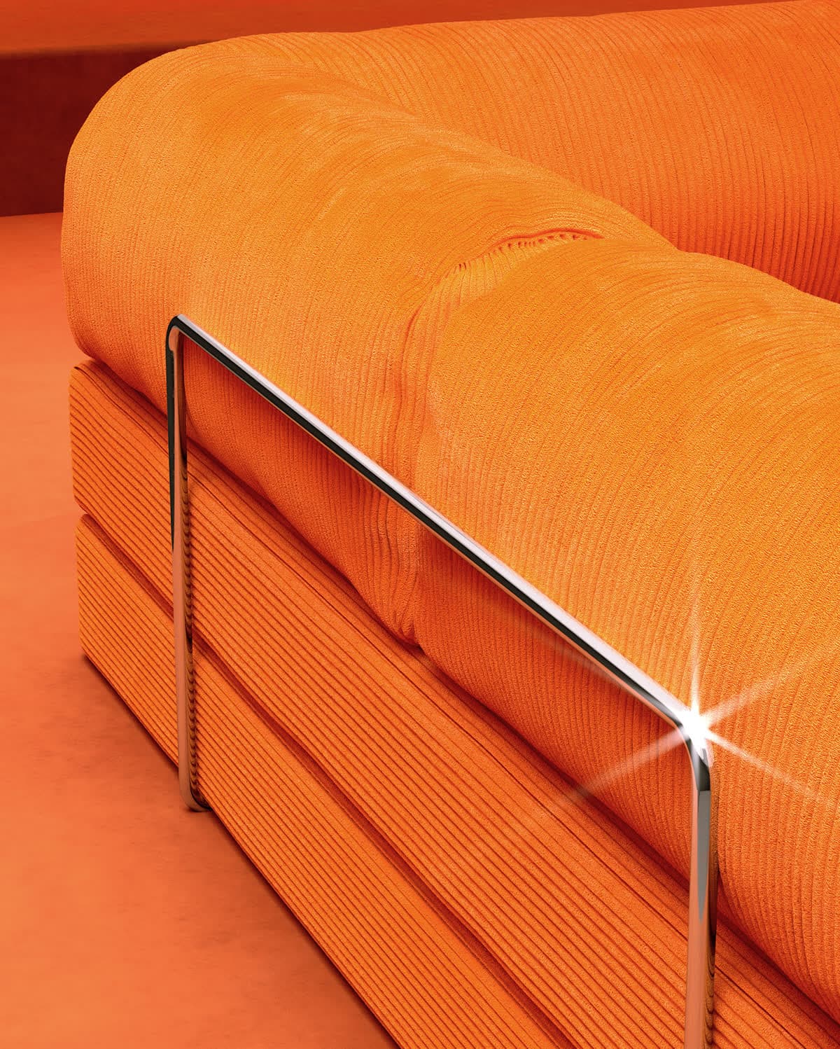 A TEDDY sofa in orange corduroy, close up on the chrome rail, with the Temu listing card over it